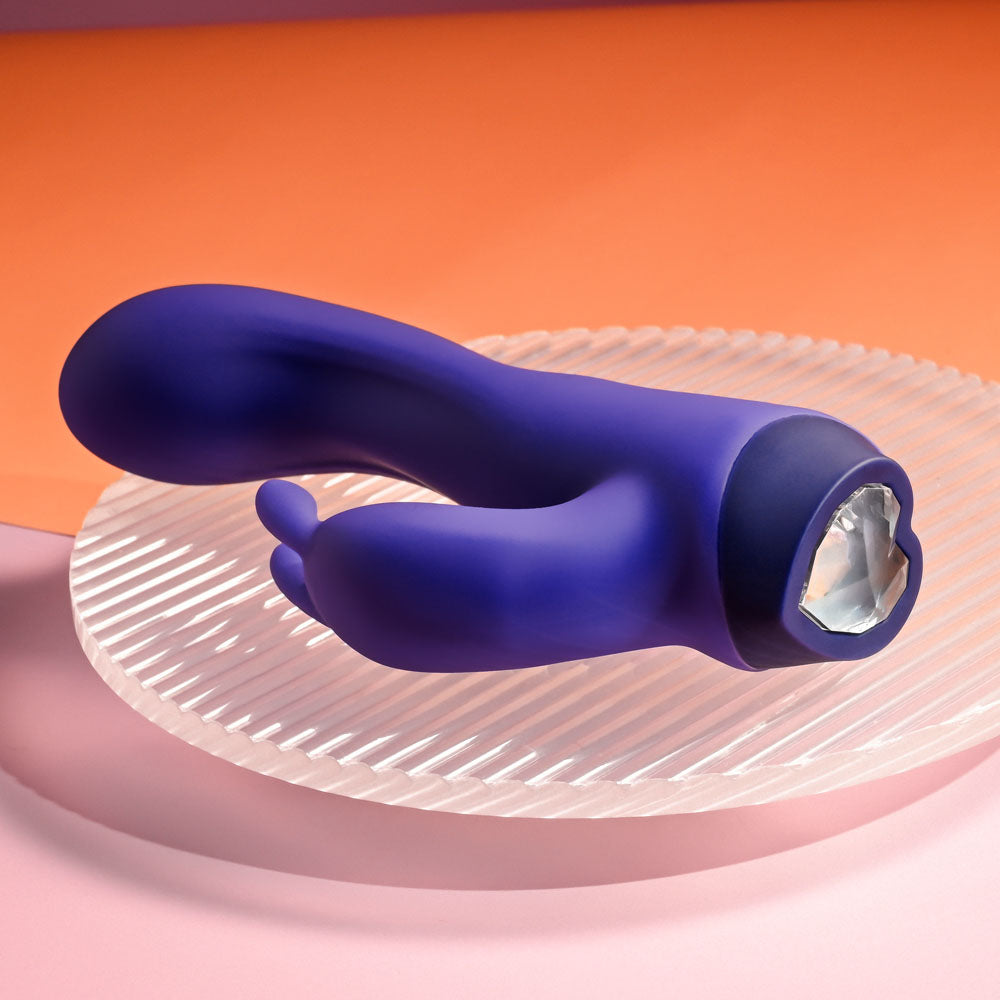 Selopa PLUM JOB -  13.5 cm USB Rechargeable Rabbit Vibrator displayed on a glass plate with orange backdrop.