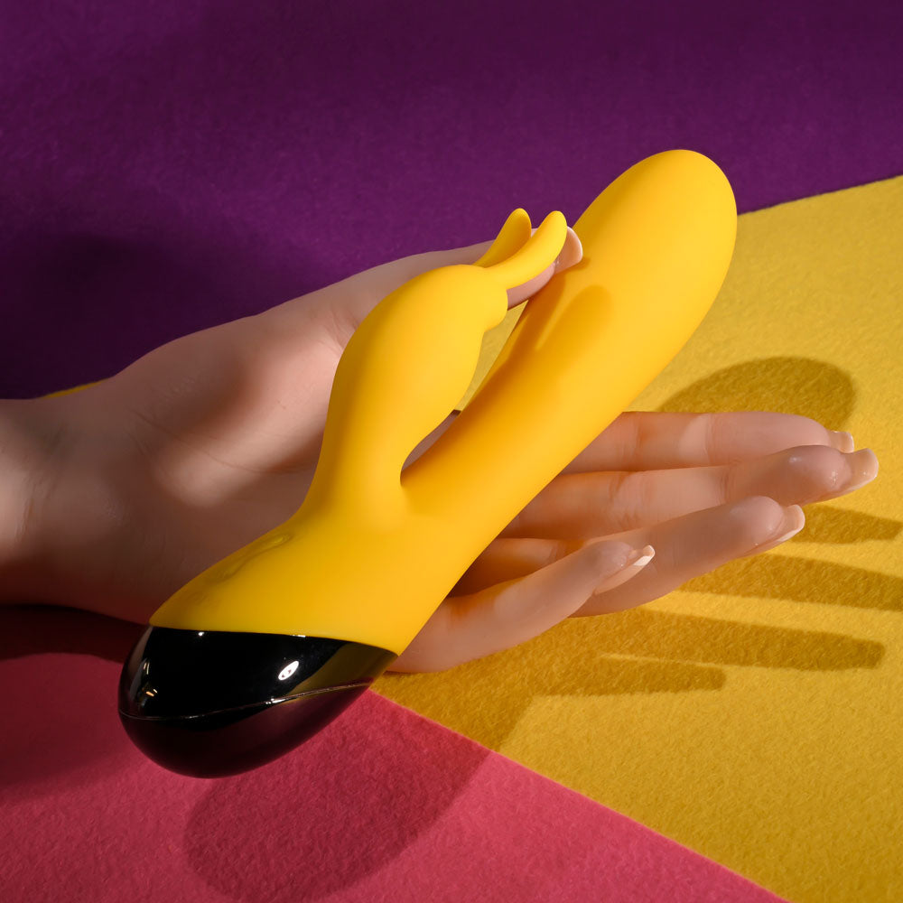 Selopa BUZZZ BUNNY - 19.7 cm USB Rechargeable Rabbit Vibrator held in hand on colorful background.
