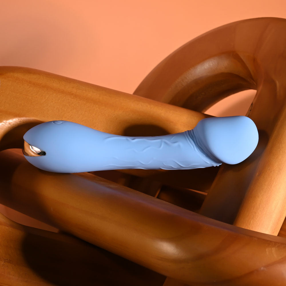 Selopa DAINTY DICK - Baby 11.9 cm USB Rechargeable Mini Vibrator on wood background, perfect for intimate essentials for her.