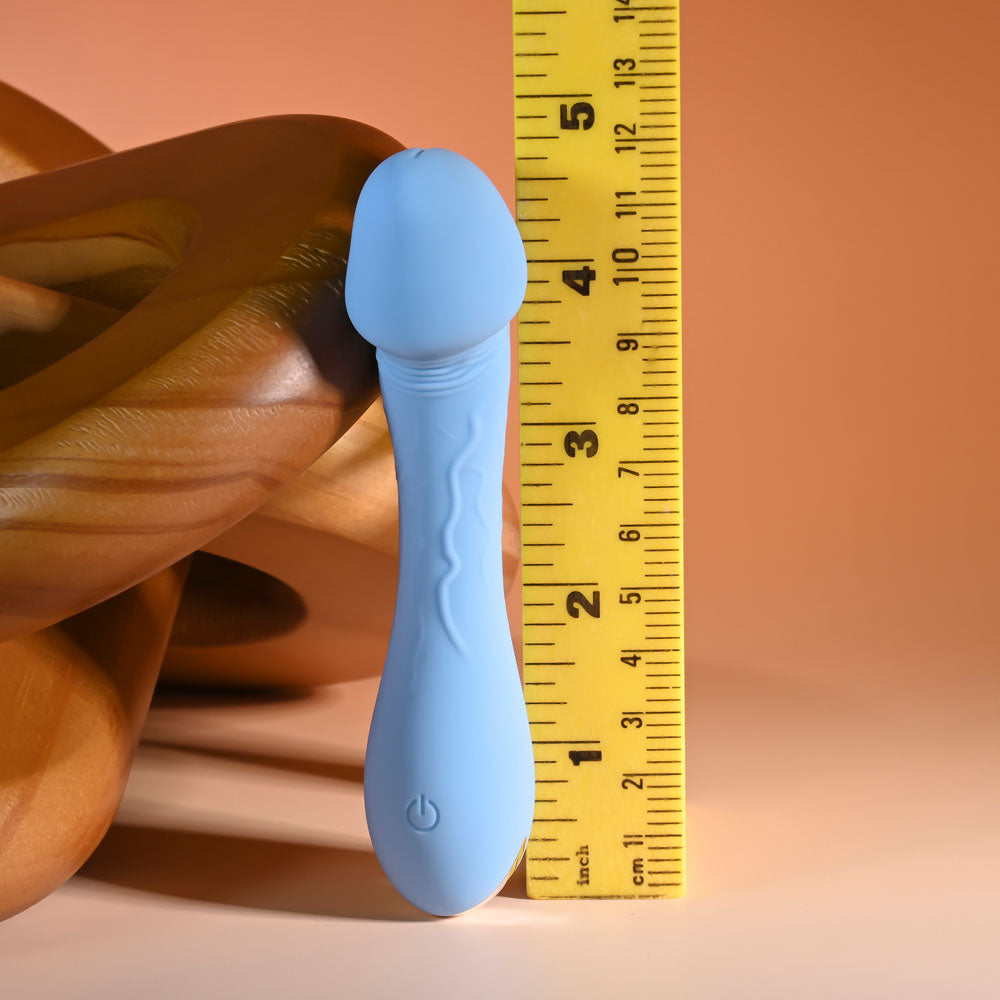 Selopa DAINTY DICK - Baby  11.9 cm USB Rechargeable Mini Vibrator next to a measuring tape for size reference.