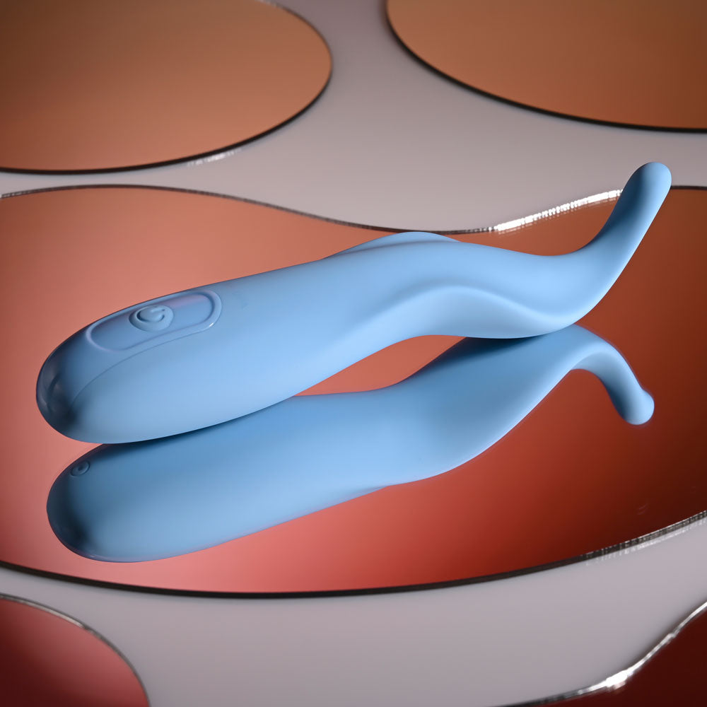 Selopa TENDER TICKLER -  16.2 cm USB Rechargeable Pinpoint Stimulator on a reflective surface.