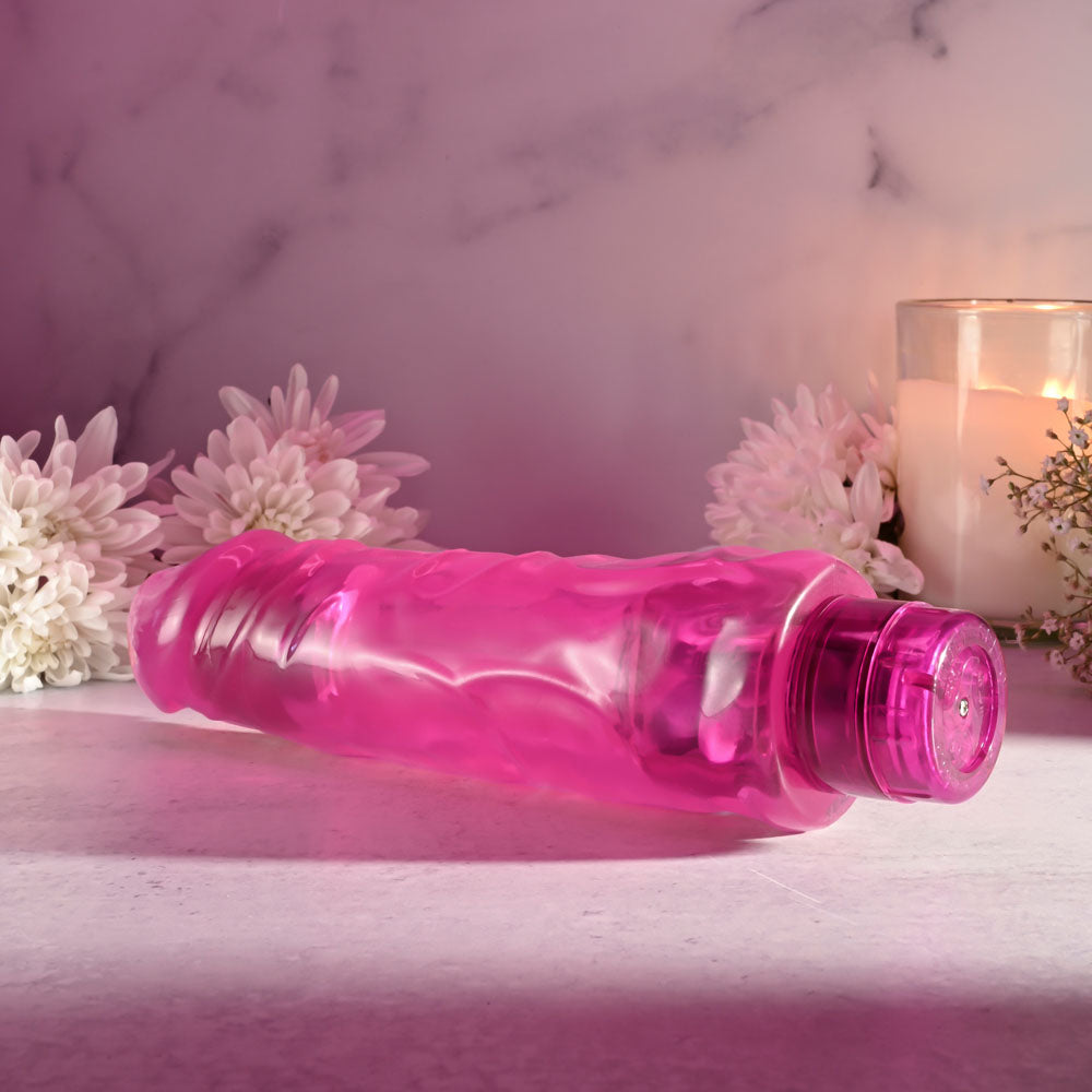 Selopa THICC BOI - 22.9 cm Vibrator in vibrant pink with realistic textures, surrounded by flowers and candles.