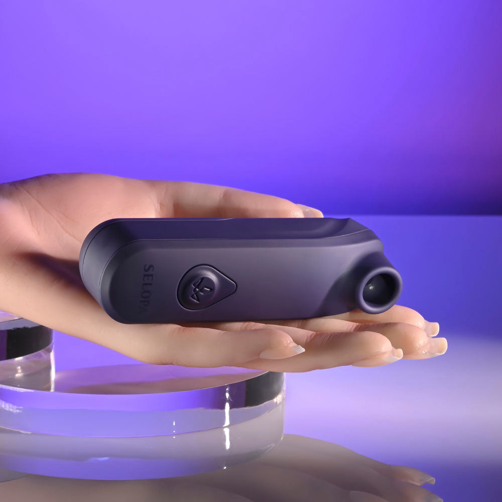 Selopa SURE THING -  Vibrating & Sucking Stimulator held in hand, showcasing its sleek design and functionality.