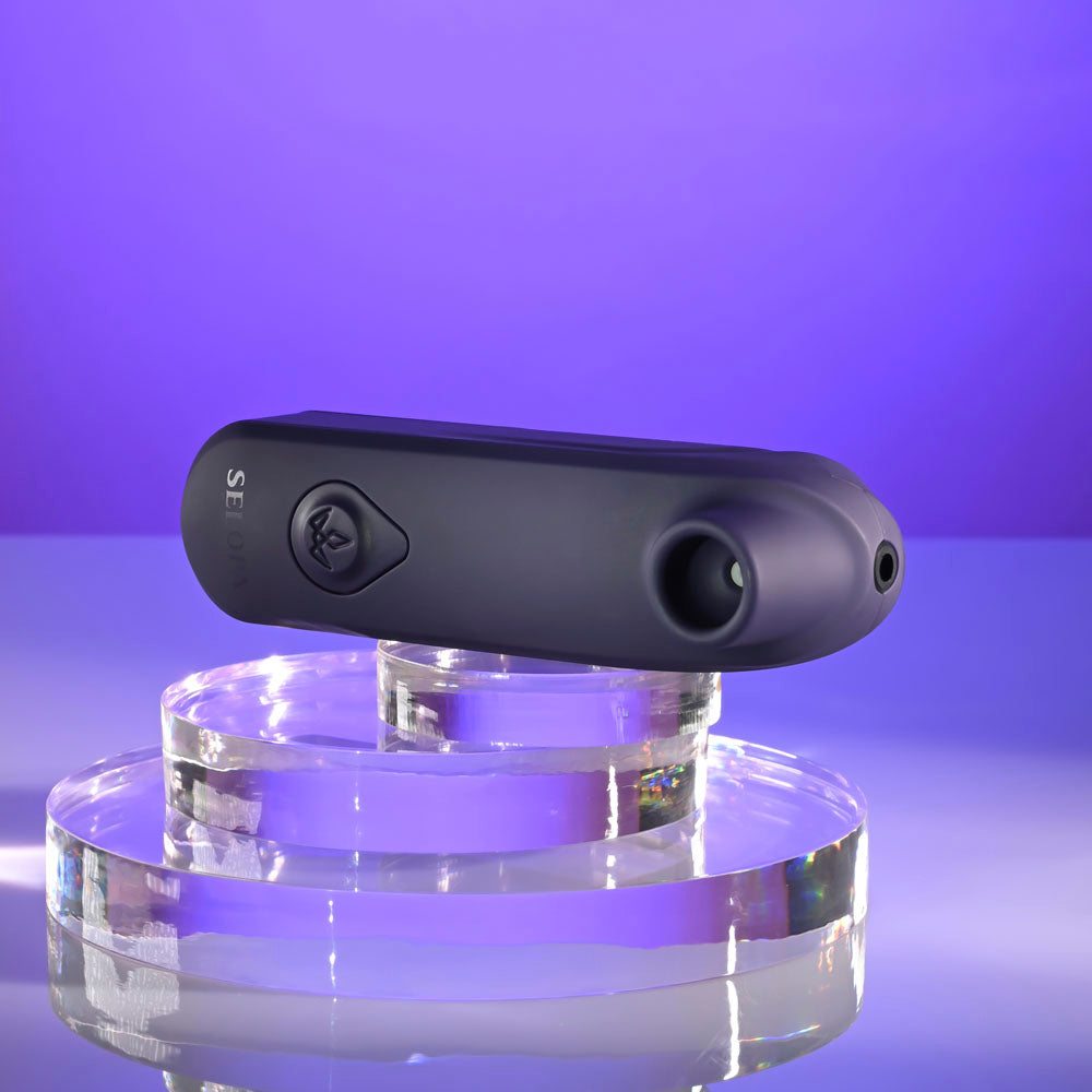 Selopa SURE THING -  Vibrating & Sucking Stimulator on display with purple background and modern base.