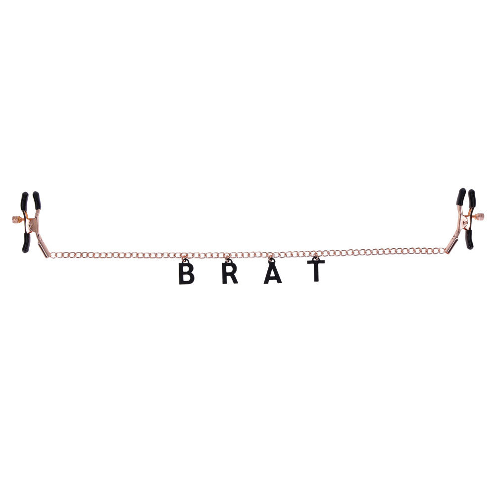 Sex & Mischief Brat Charmed Nipple Clamps -  Nipple Clamps with 45 cm Chain displayed with BRAT letters.
