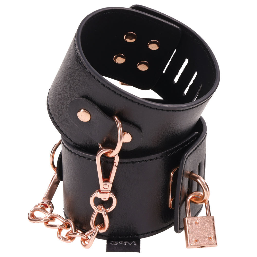 Sex & Mischief Brat Locking Cuffs - /Rose Gold Hand Cuffs made of black vegan leather with rose gold accents and chain.