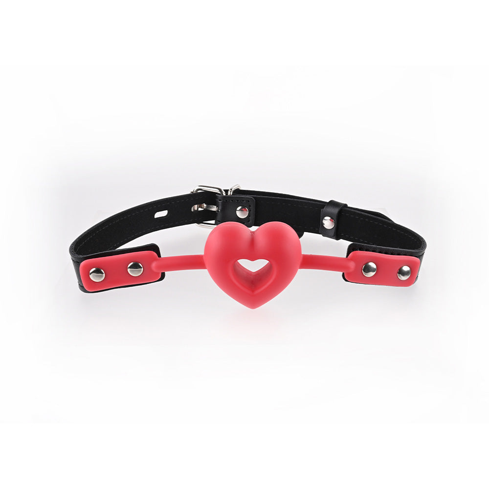 Sex & Mischief Amor Ball Gag - /Black Mouth Restraint in red heart-shaped design with adjustable black strap.
