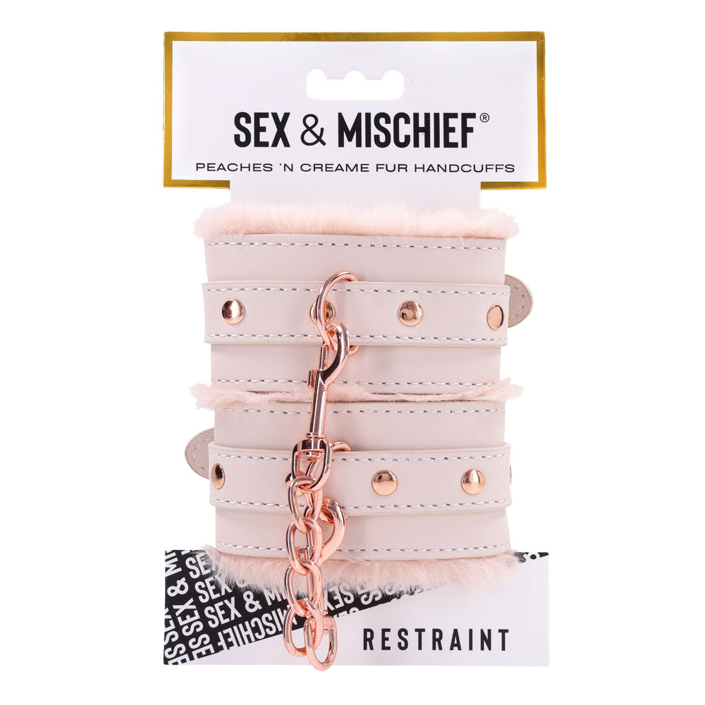 Sex & Mischief Peaches n CreaMe Fur Handcuffs - Peach Restraints on display with soft faux fur and metallic details.