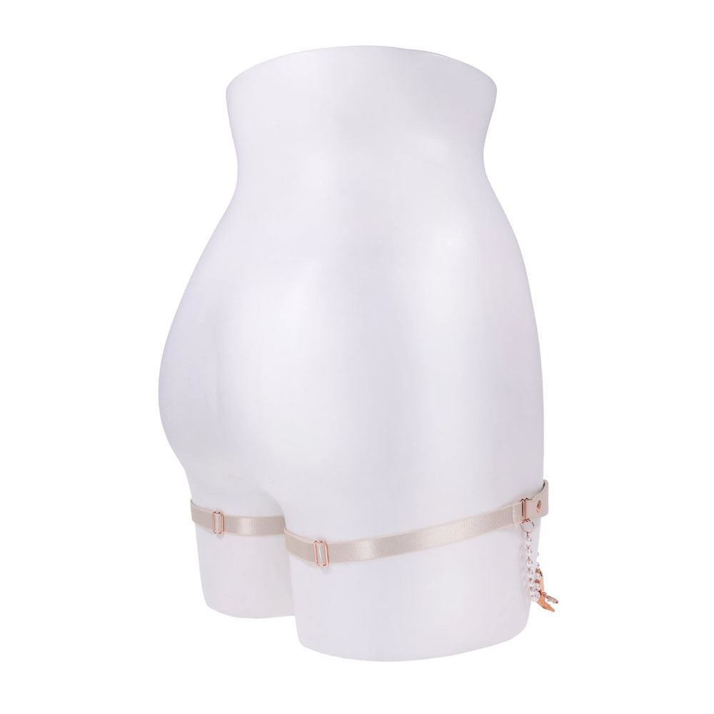 Sex & Mischief Peaches n CreaMe Pearl Garters - Peach / Rose Gold Garters with Pearls - Set of 2 displayed on a mannequin.