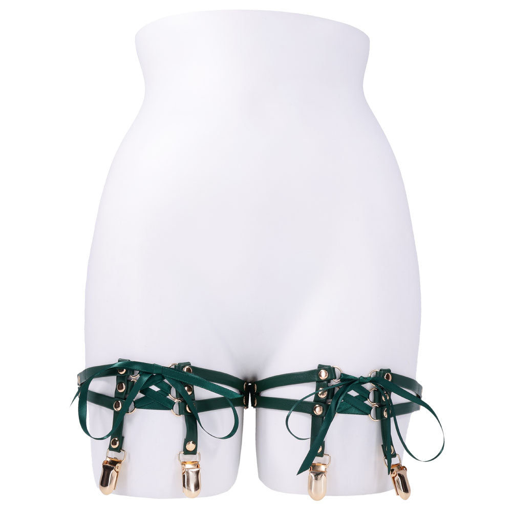 Sex & Mischief Indica Laced Up Garters - /Gold Garters - Set of 2 displayed on a mannequin, featuring green faux leather and satin laces.