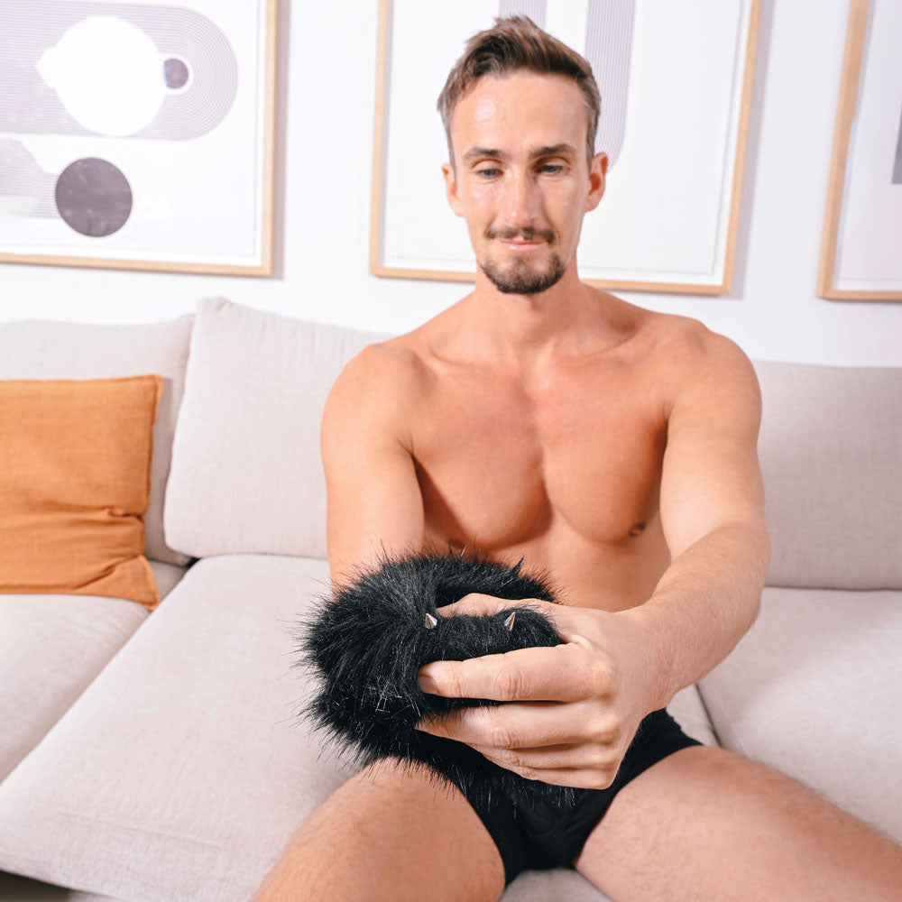 SPORTSHEETS Spiked Sensory Mitt -  Furry Mitt with Spikes in a man's hand, showcasing its textured design.
