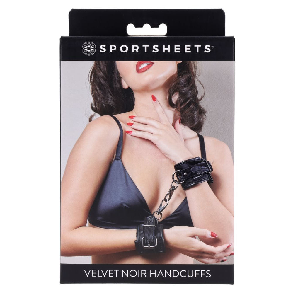 SPORTSHEETS Velvet Noir Handcuffs -  Adjustable Cuff Restraints packaging displayed with a model in a black top.