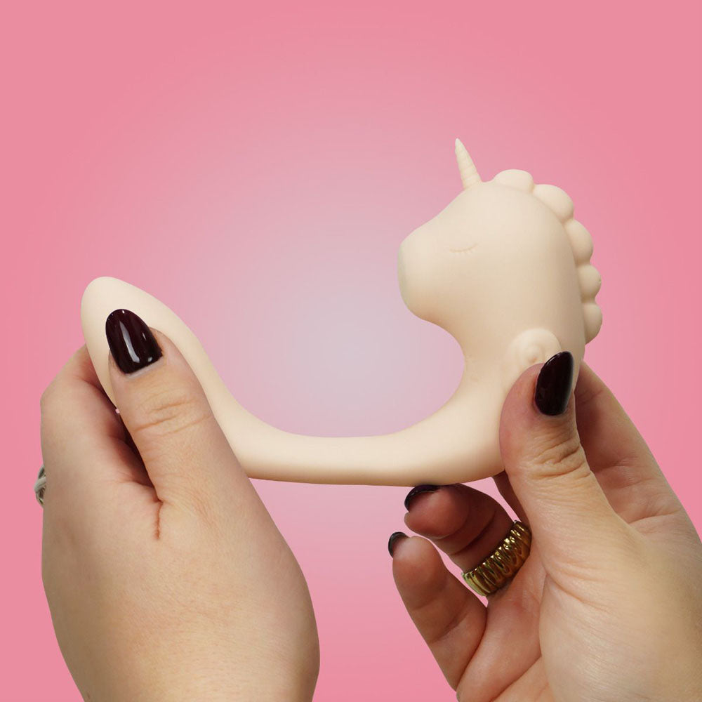 Unihorn - C Horse - Coral Throb - Coral USB Rechargeable Dual Unicorn Vibrator held in hands against a pink background.