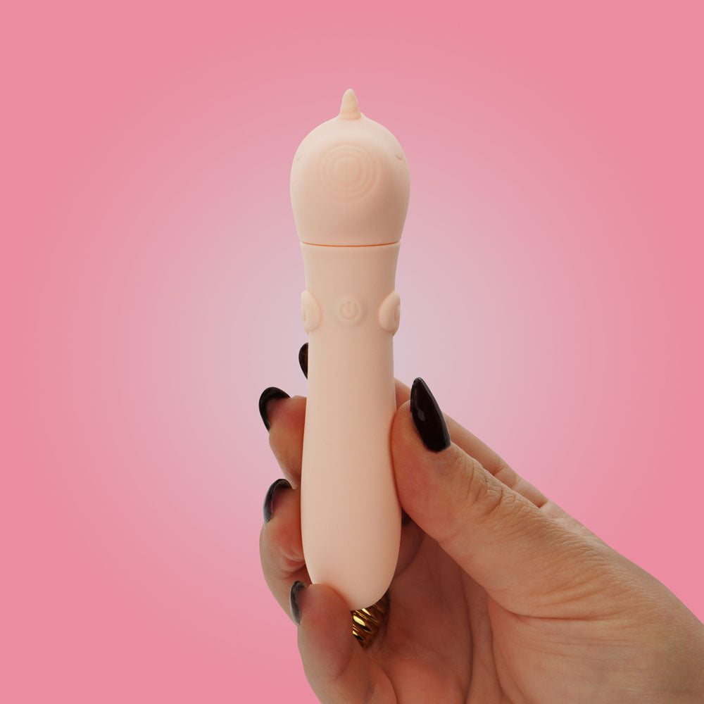 Unihorn - USB Bullet - Heart Throb - Coral USB Rechargeable Vibrating Bullet held in hand against a pink background.