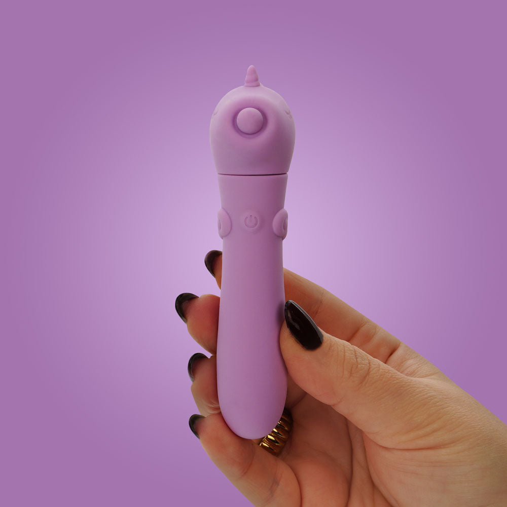 Unihorn - USB Bullet - Karma Lilac - Lilac USB Rechargeable Vibrating Bullet held by hand against a purple background.