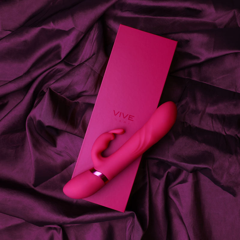VIVE Nari -  -  24.1 cm USB Rechargeable Rabbit Vibrator on a pink satin background with its box.