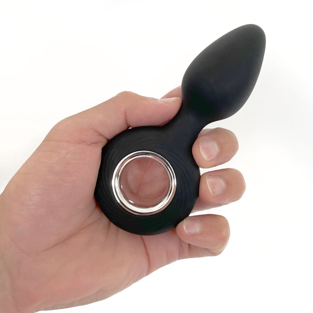VERS Rechargeable Silicone Plug Vibe - 12.5 cm USB Rechargeable Vibrating Butt Plug in a hand, showcasing its ergonomic design.
