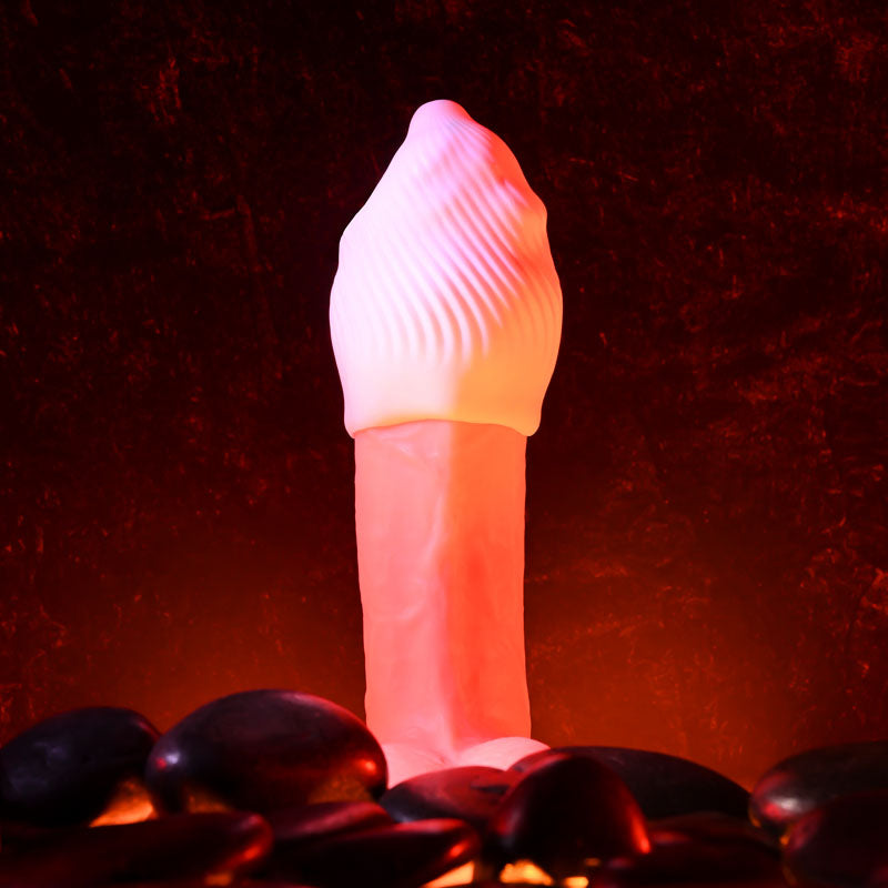 Zero Tolerance KILAUEA - Mini Stroker Egg displayed among black stones, featuring a textured design for enhanced pleasure.