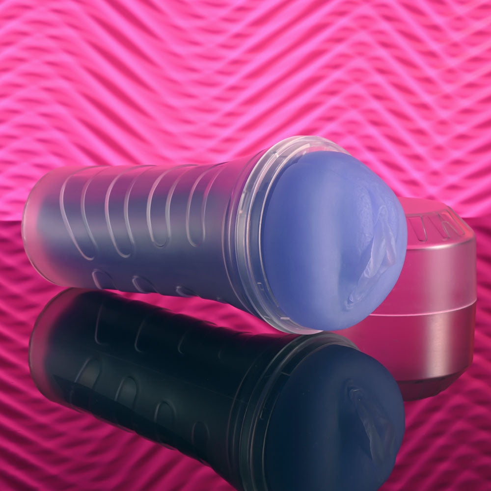 Zero Tolerance POP ON THE GLOW - Glow in Dark  Vagina Stroker on reflective surface with vibrant background.