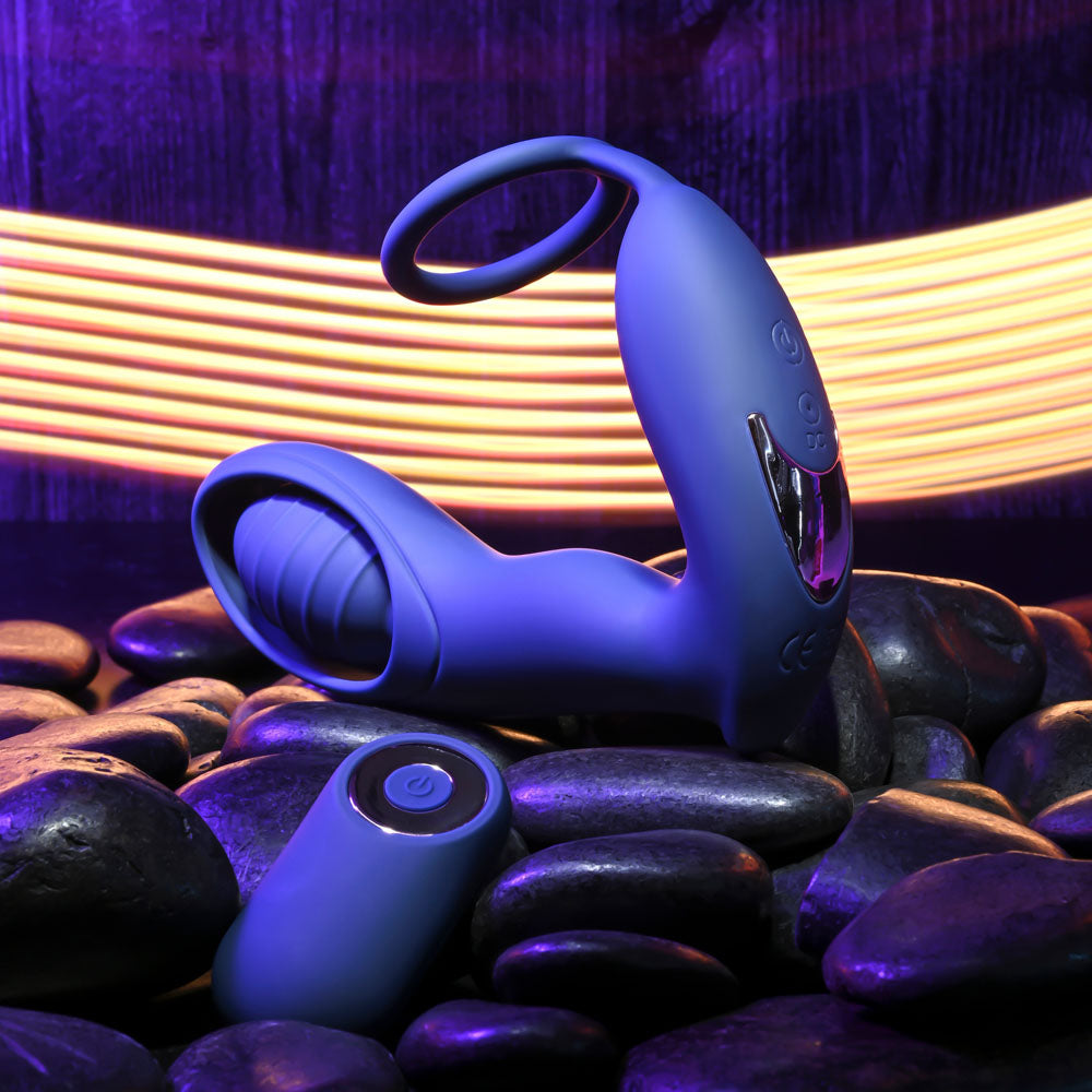 Zero Tolerance EXTRA MILE -  USB Rechargeable Vibrating Prostate Massager on smooth stones with vibrant light backdrop.