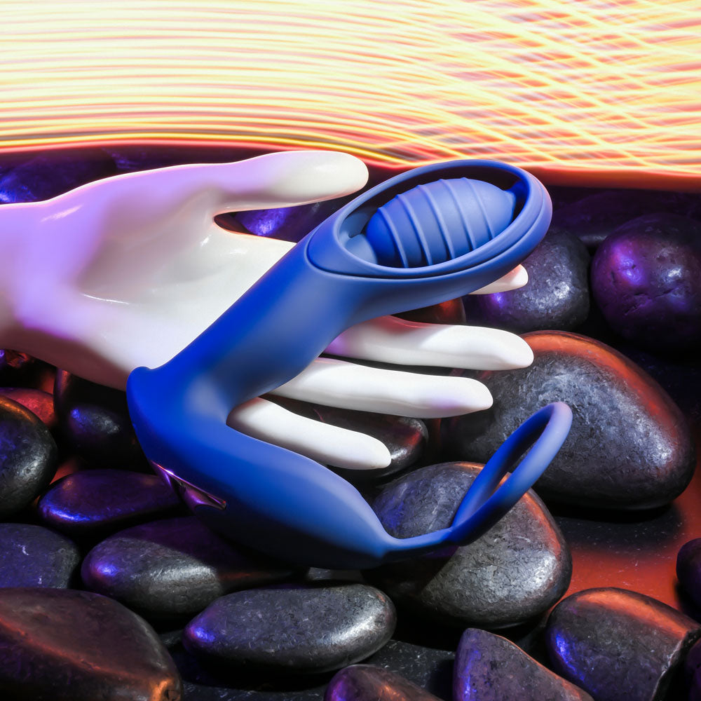 Zero Tolerance EXTRA MILE -  USB Rechargeable Vibrating Prostate Massager on stones with hand.