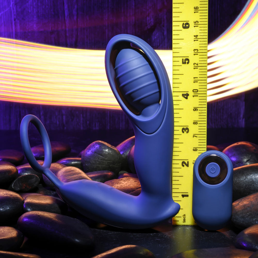 Zero Tolerance EXTRA MILE -  USB Rechargeable Vibrating Prostate Massager next to a measuring ruler on smooth stones.