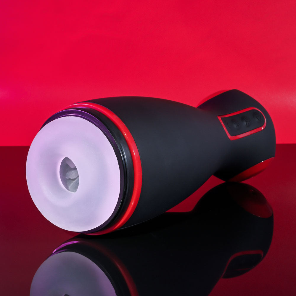 Zero Tolerance TIGHT SQUEEZE - USB Rechargeable Vibrating, Squeezing & Talking Stroker on glossy surface with red background.