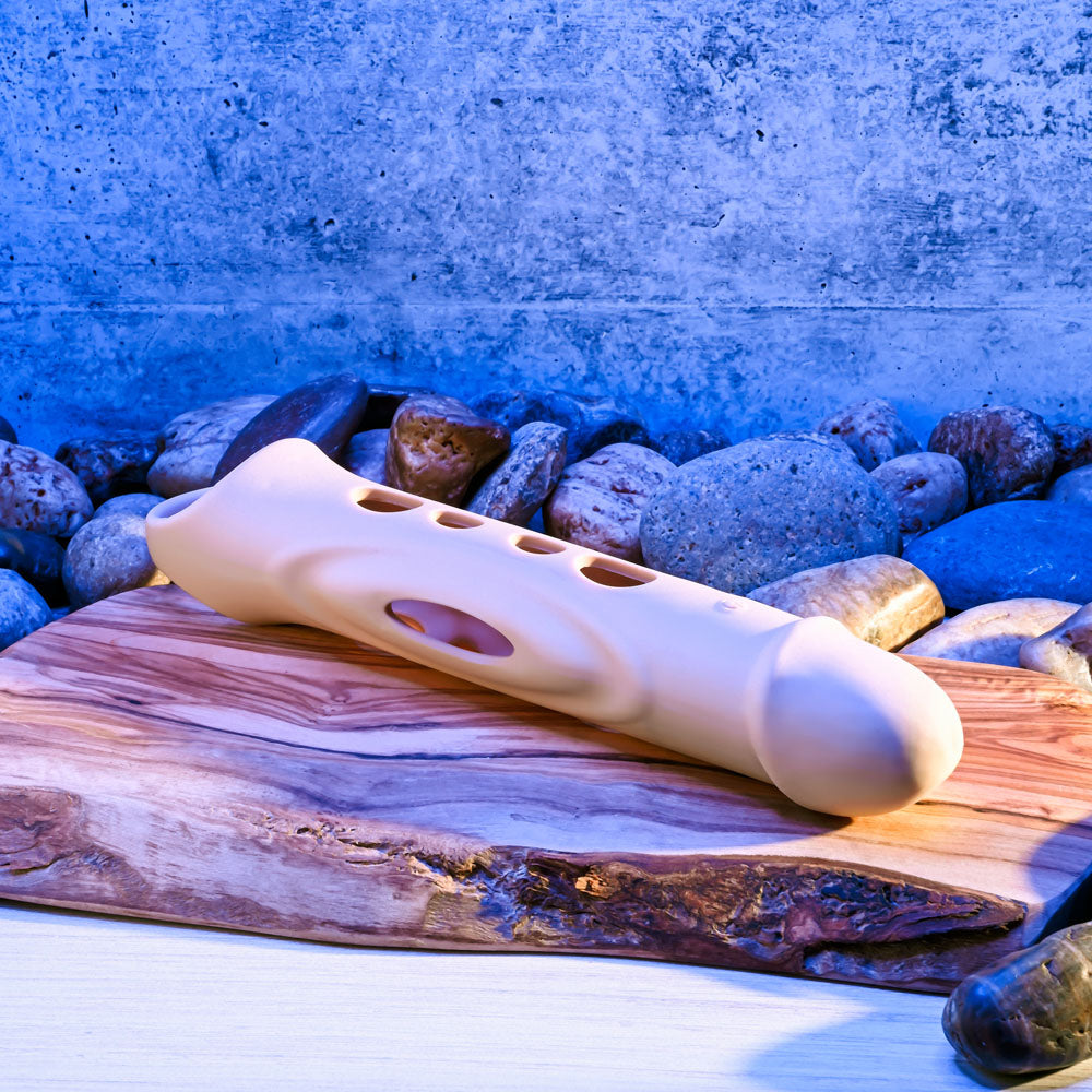 Zero Tolerance BIG BOY EXTENDER - Light -  USB Rechargeable Vibrating Penis Extension Sleeve on a rustic wooden surface.