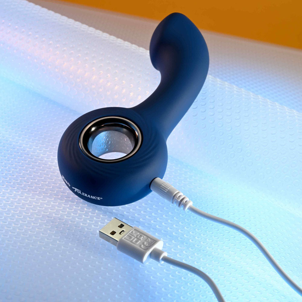 Zero Tolerance THE REACH - 13.8 cm USB Rechargeable Vibrating Anal Plug charging on a vibrant background.