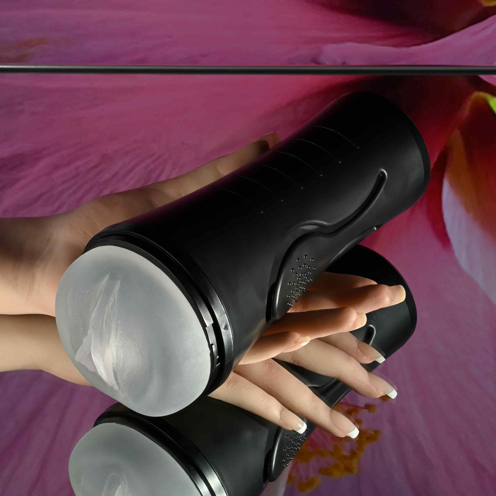 Zero Tolerance HOLD TIGHT - USB Rechargeable Vibrating Vagina Stroker in a hand on a reflective surface.