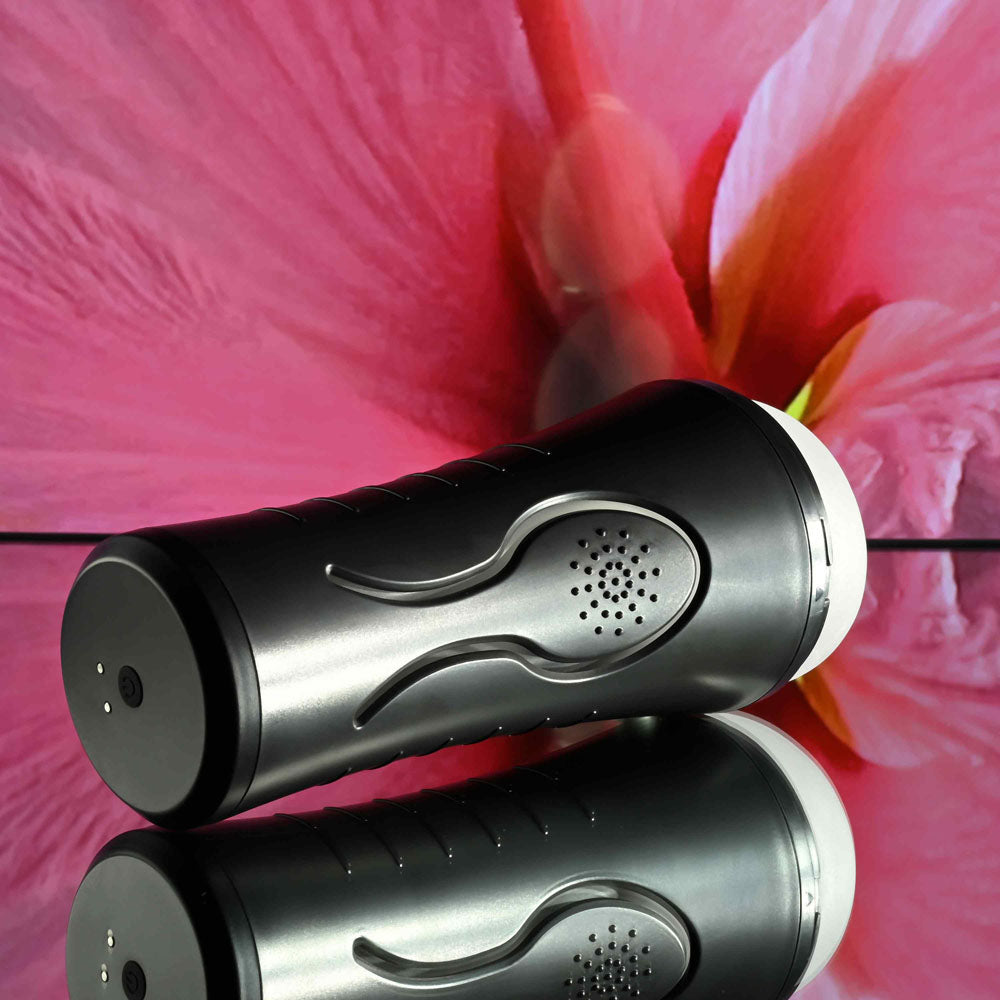 Zero Tolerance HOLD TIGHT -  USB Rechargeable Vibrating Vagina Stroker on reflective surface with floral background.