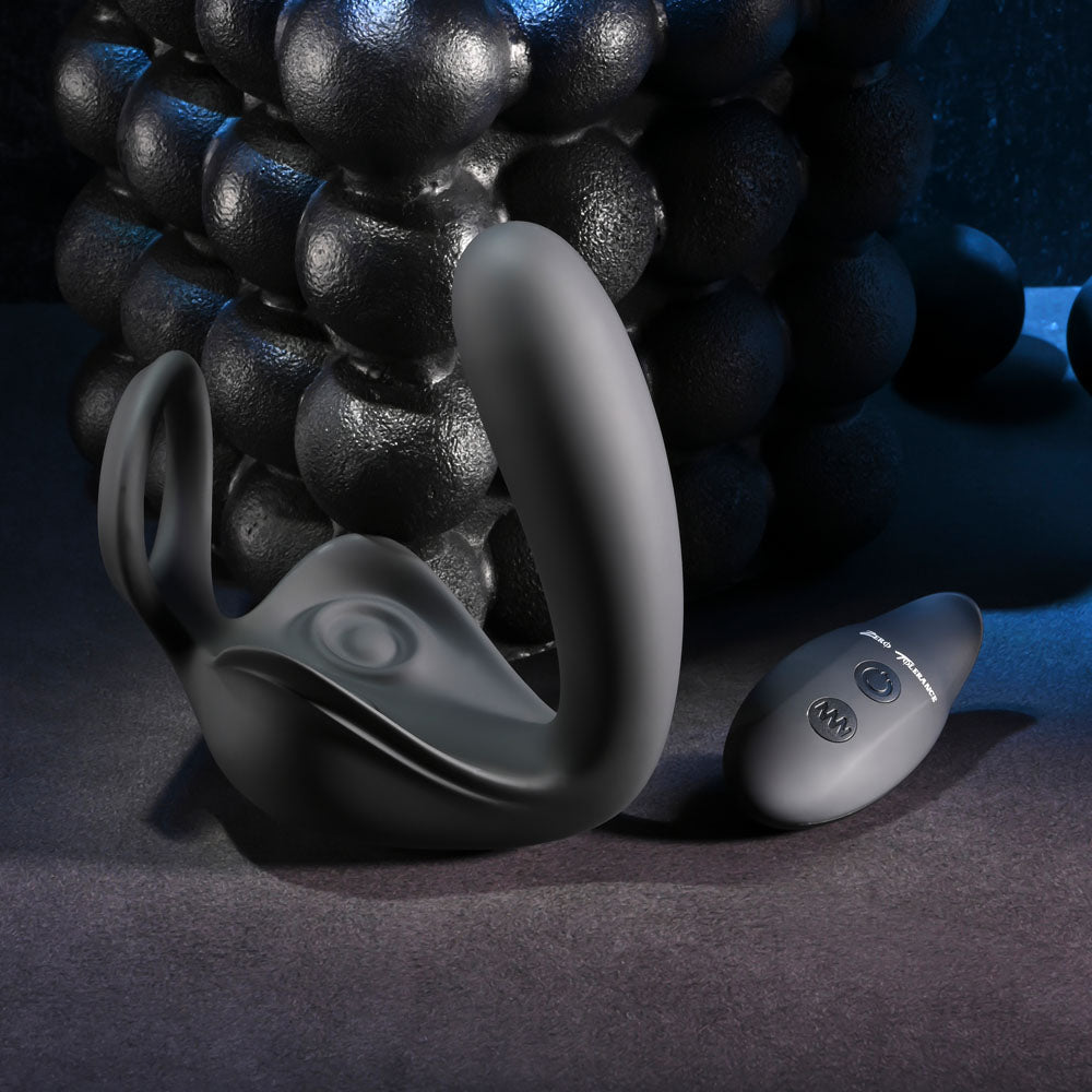 Zero Tolerance BALLIN OUT -  USB Rechargeable Prostate Massager with Cock Ring and Wireless Remote next to its remote control.