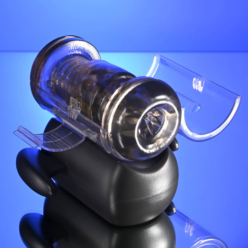 Zero Tolerance HOLD ME TIGHT -  USB Rechargeable Vibrating Auto Stroker with Phone Holder on a reflective surface.