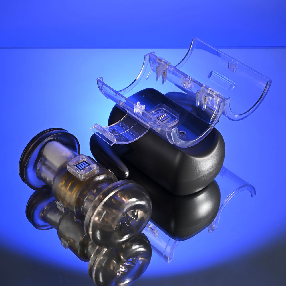 Zero Tolerance HOLD ME TIGHT -  USB Rechargeable Vibrating Auto Stroker with Phone Holder on reflective surface.