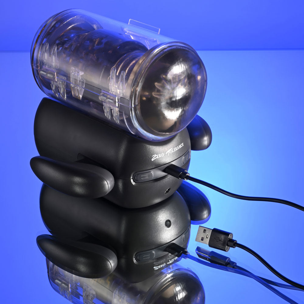 Zero Tolerance HOLD ME TIGHT -  USB Rechargeable Vibrating Auto Stroker with Phone Holder placed on reflective surface.