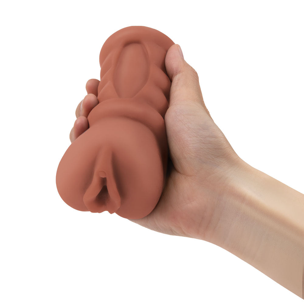 Zolo Stroke Off Latina Pussy Stroker - Tan Vagina Stroker held in hand, highlighting its lifelike design and soft texture.